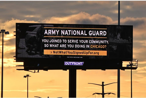 Billboard: ARMY NATIONAL GUARD YOU JOINED TO SERVE YOUR COMMUNITY. SO WHAT ARE YOU DOING IN CHICAGO?