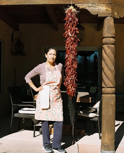 Deb standing next to a bunch of New Mexico chiles!